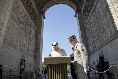 President Sheikh Mohamed signs a guest book during a military ceremony at the Arc de Triomphe in Paris. Photo: Presidential Court