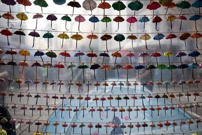 Small paper umbrellas — symbols of the pro-democracy protests in Hong Kong — are strung up in a display at the site of protest in the Causeway Bay area of Hong Kong. Alex Ogle / AFP     
