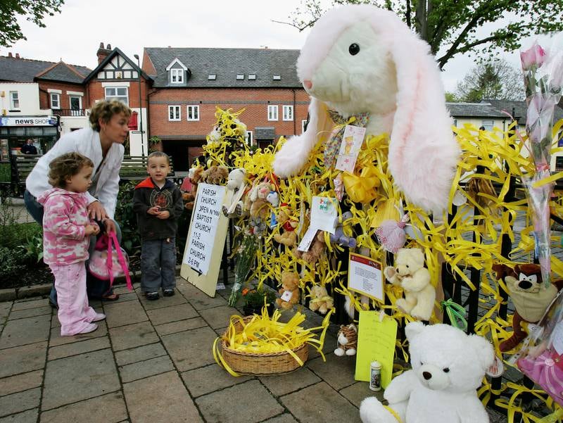 A mother and her children show their support for the missing girl in Rothley, the McCanns' town, in May 2007.