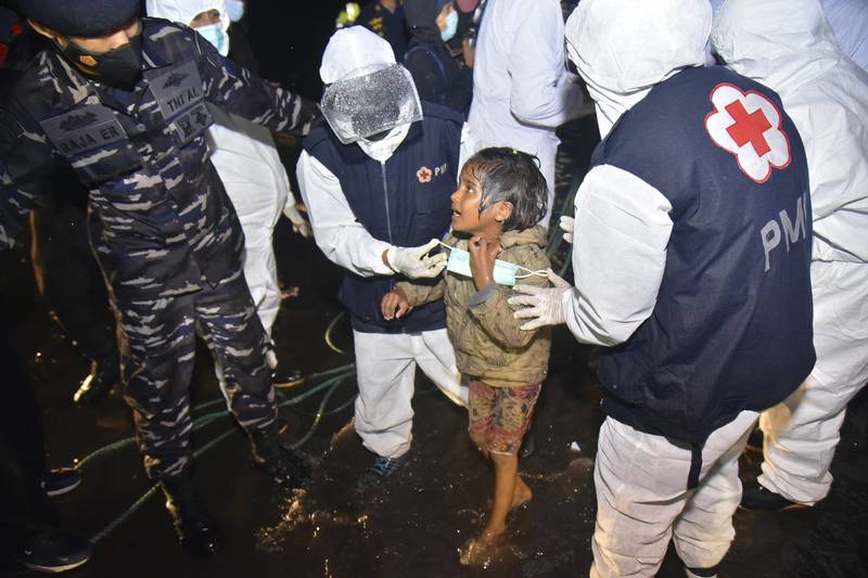 Medical workers help a Rohingya girl after her arrival in North Aceh, Indonesia, last year.  AP
