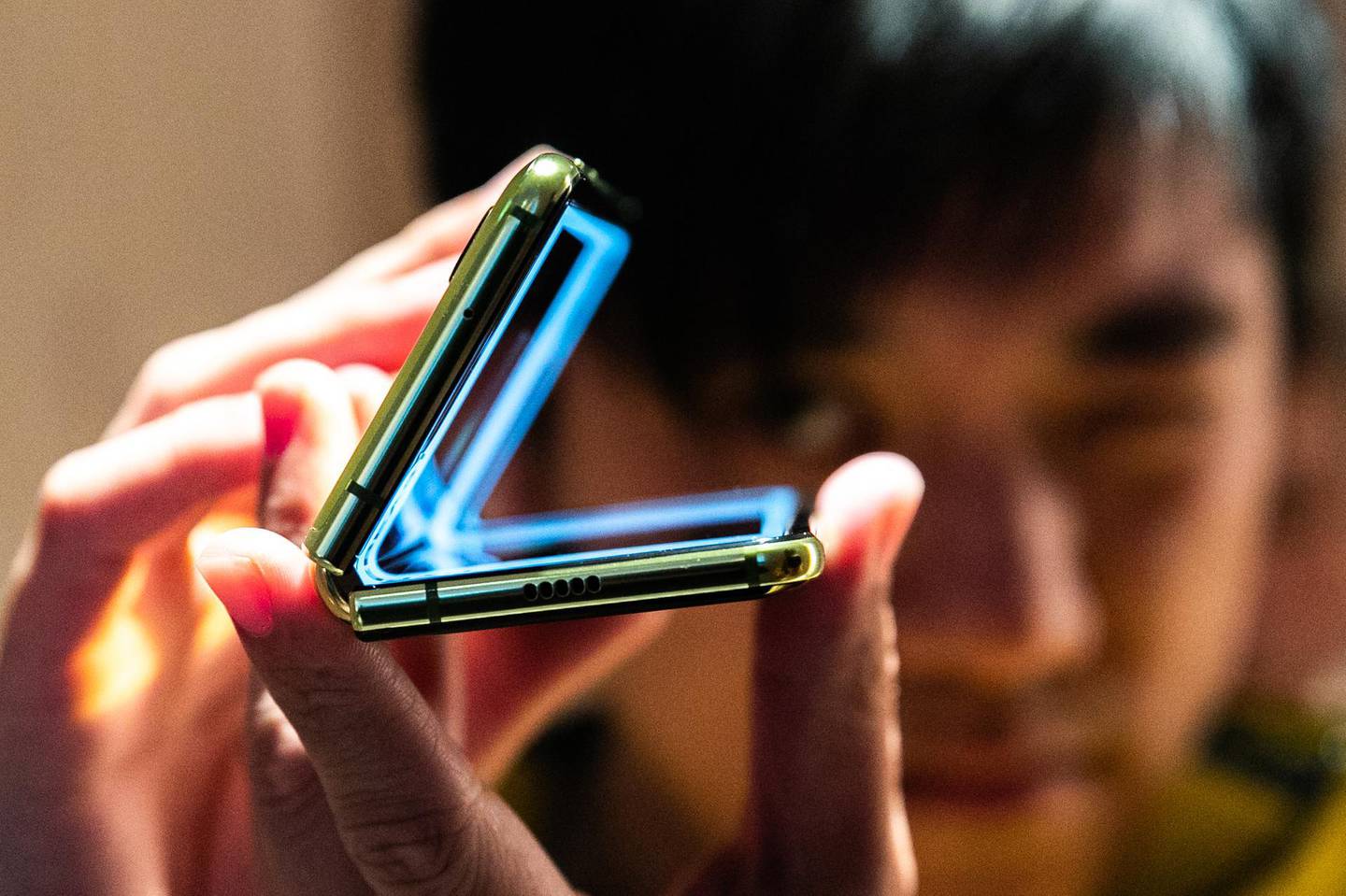 An attendee holds a Samsung Electronics Co. Galaxy Fold mobile device during an unveiling event in New York, U.S., on Monday, April 15, 2019. Samsung announced the phone in February and it goes on sale April 26 at the wallet-stretching price of $1,980. Photographer: Jeenah Moon/Bloomberg