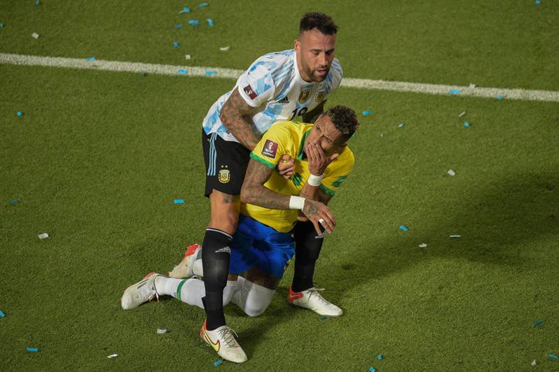 Argentina's Nicolas Otamendi lifts Brazil's Raphinha from the ground after their controversial collision. AFP