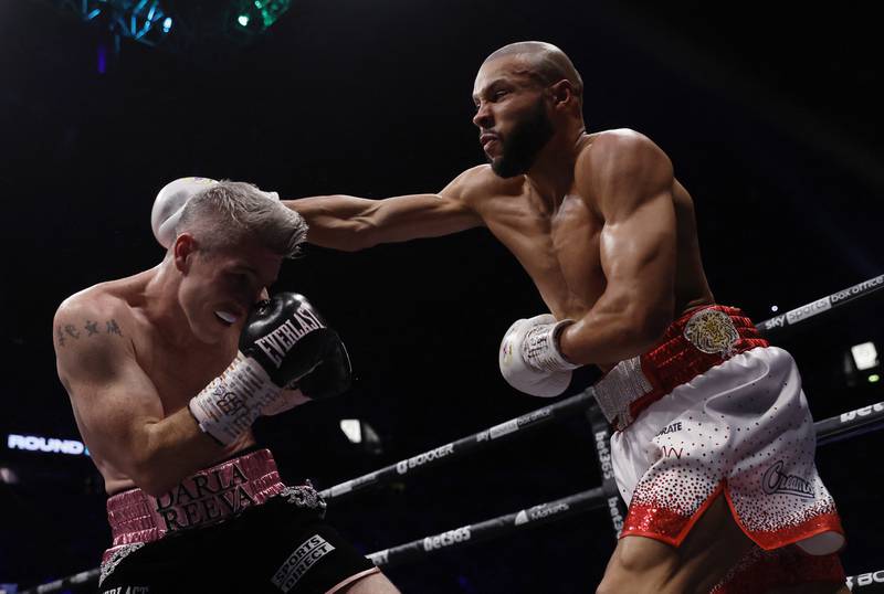 Chris Eubank Jr throws a punch at Liam Smith during their fight. Reuters