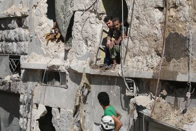 Men inspect a site damaged after an airstrike in the besieged rebel-held al-Qaterji neighbourhood of Aleppo, Syria October 11, 2016. REUTERS/Abdalrhman Ismail