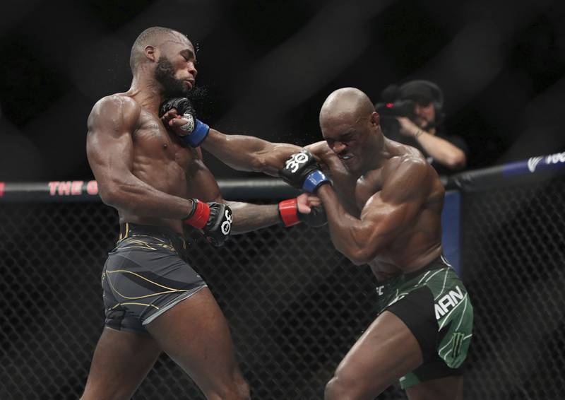 Leon Edwards and Kamaru Usman exchange blows during their welterweight title bout at at UFC 286. PA