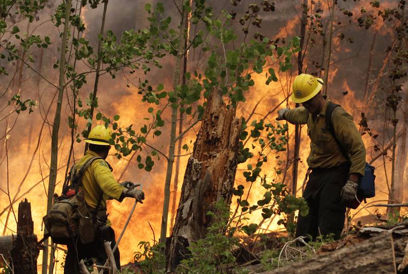 US firefighters battle a blaze near Los Alamos, New Mexico,  in 2011. AP Photo
