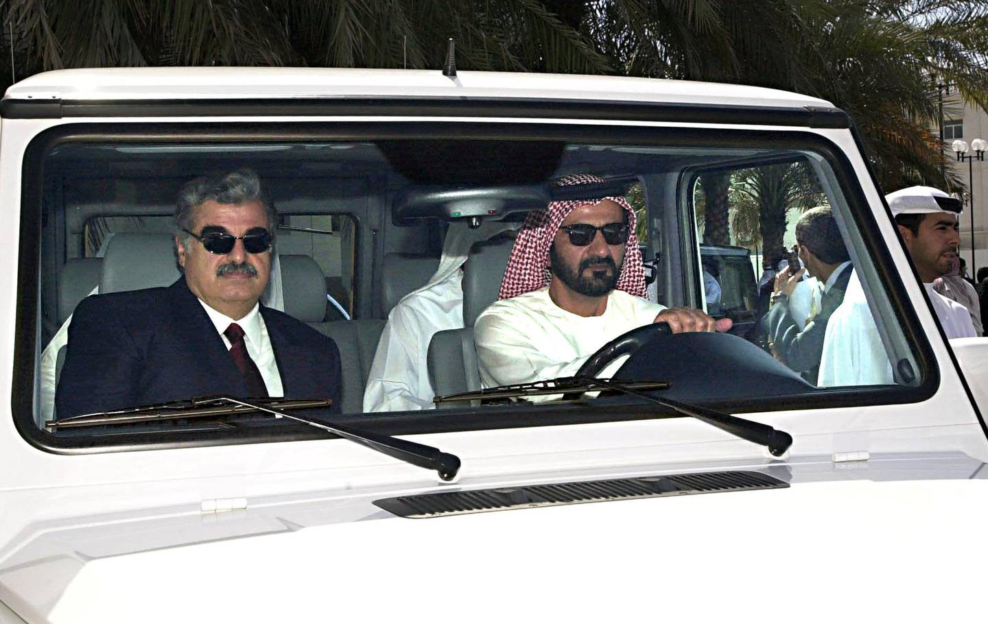 Crown Prince of Dubai Mohammed bin Rashed al Maktoum (R) drives former Lebanese Premier and head of the Lebanese parliamentary opposition Rafic Hariri in Dubai 06 March 2000. Hariri is on a two-day visit to the Emirate. (Photo by AYMAN TARAWI / HARIRI FOUNDATION / AFP)