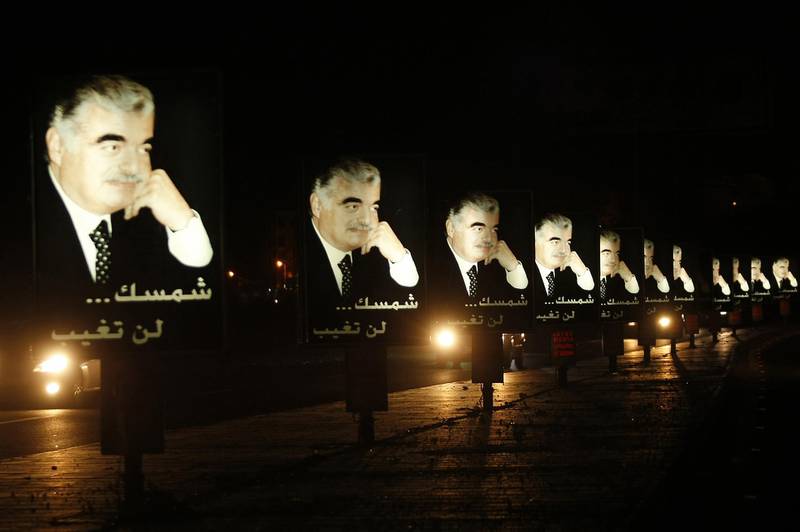 (FILES) A file photo taken on February 13, 2012 shows billboards bearing portraits of Lebanese ex-premier Rafiq Hariri are pictured on the Sidon-Beirut highway in southern Lebanon on the eve of the anniversary of his assassination in 2005. A massive bomb tore through Hariri's armoured convoy as he drove home for lunch on Valentine's Day 2005, killing him and 21 other people including seven of his bodyguards, as well as wounding 226 others. A UN-backed court is to deliver its judgement on August 7, 2020, on four suspected Hezbollah members tried in absentia for former Lebanese premier Rafic Hariri's murder in a 2005 Beirut car bombing. / AFP / Mahmoud ZAYYAT
