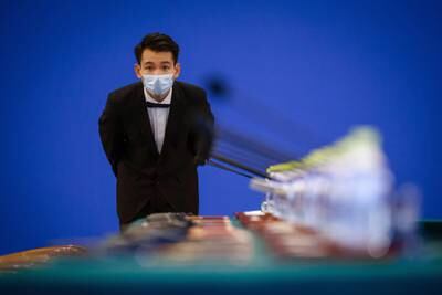 An attendant checks the table ahead of the 9th China-France High Level Economic and Financial Dialogue in Beijing, China. EPA