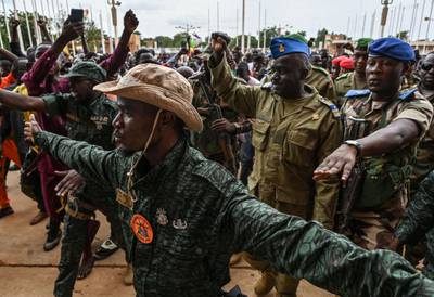 Col-Maj Amadou Abdramane, second right, is greeted by supporters at the Stade General Seyni Kountche in Niamey, Niger. AFP