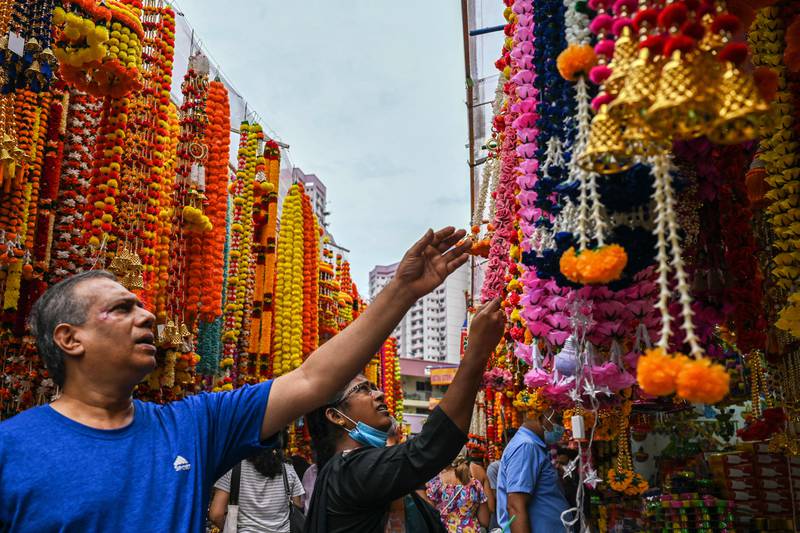 People looks at decorative ornaments on sale for Diwali in the Little India district of Singapore. AFP