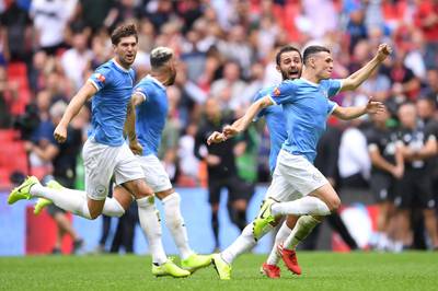 Silva, Phil Foden and John Stones of Manchester City celebrate. Getty