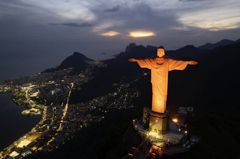 Christ the Redeemer is illuminated in orange to mark 21 days of activism against gender-based violence in Rio de Janeiro, a movement calling for the prevention of violence against women and girls. AP