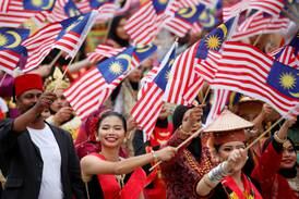 Performers with Malaysia flags celebrate National Day at Putrajaya last month. Malaysia's is a cosmopolitan society. Reuters