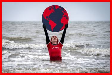 PABest Susie Gray, from the Edinburgh Science Festival team, stands in the Firth of Forth at Portobello in Edinburgh, holding a giant black and red Earth to highlight the climate emergency and rising sea levels ahead of Earth Day on Friday April 22, 2022. Picture date: Thursday April 21, 2022.