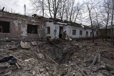 A Ukrainian soldier at a psychiatric hospital damaged by a Russian bombing, in Mykolaiv. AP