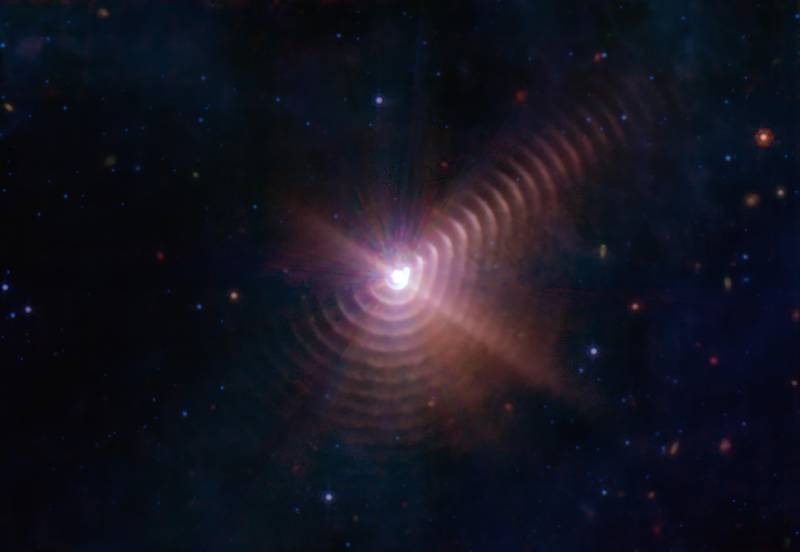 Dust rings resembling a fingerprint created by a rare type of star and its companion. PA
