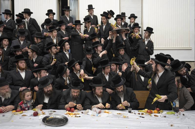 Ultra-Orthodox Jews of the Zweil Hasidim distribute fruit at the feast of Tu Bishvat in Jerusalem. AP

