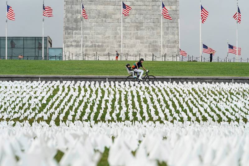 A cyclist rides past the 'In America: Remember' memorial. Reuters