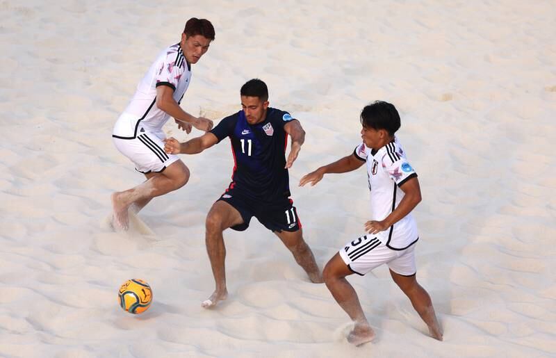 Andres Navas of the US is marked by two Japanese players. Getty