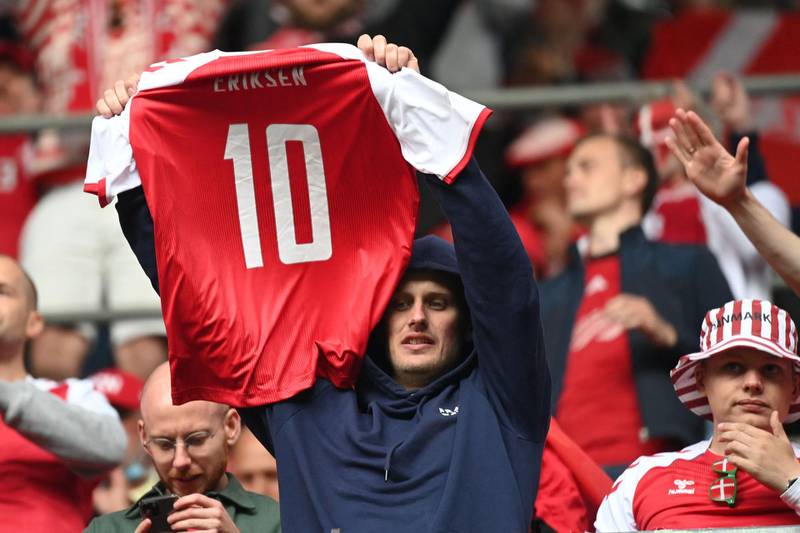 A Denmark fan holds up a Christian Eriksen shirt AFP