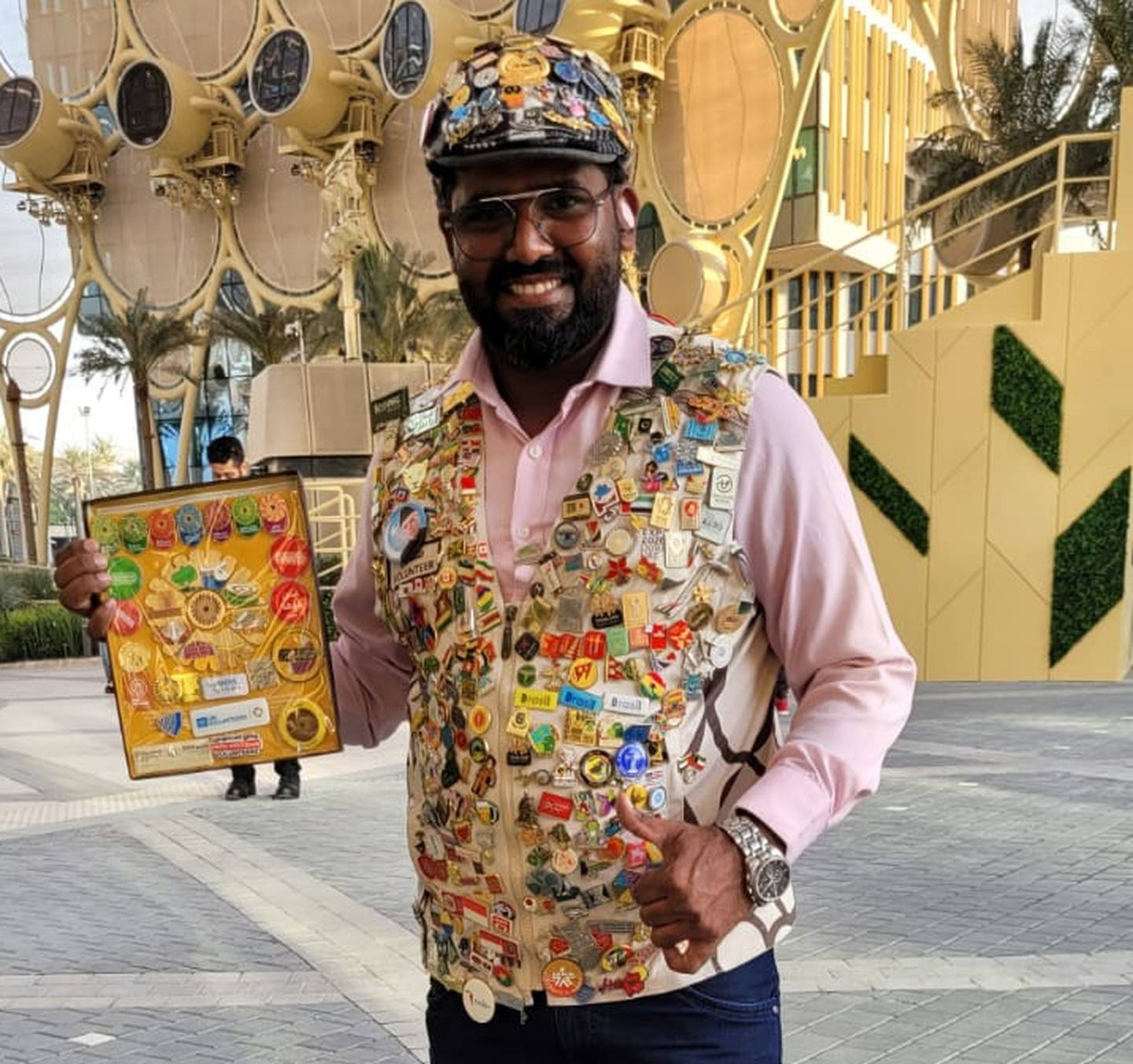 Umair Jamil and his jacket featuring more than 700 Expo-themed badges.