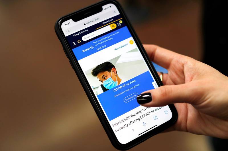 The Walmart Mobile app is seen on a mobile phone at a Walmart pharmacy where the Moderna coronavirus disease vaccine is available as Walmart and other major U.S. pharmacies take part in the Federal Retail Pharmacy Program, to increase vaccinations in the U.S. in West Haven, Connecticut, U.S. Reuters