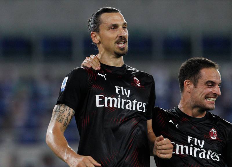 AC Milan's Zlatan Ibrahimovic, left, celebrates with his teammate Giacomo Bonaventura after scoring his side's second goal during the Serie A soccer match between Lazio and AC Milan at the Rome Olympic stadium, Saturday, July 4, 2020. (AP Photo/Riccardo De Luca)