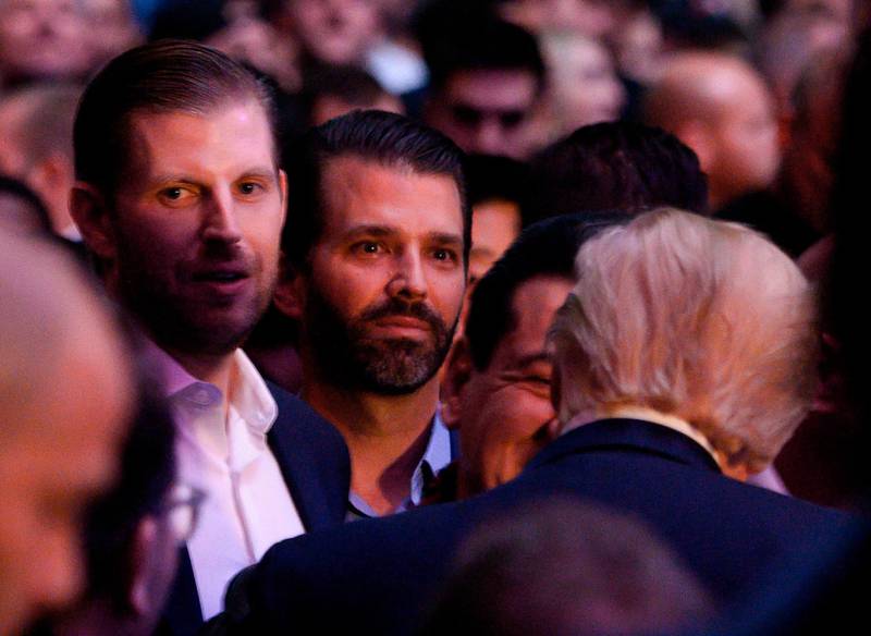 Eric Trump, left, Donald Trump Jr., centre, join their father Donald Trump to watch UFC 244. AFP