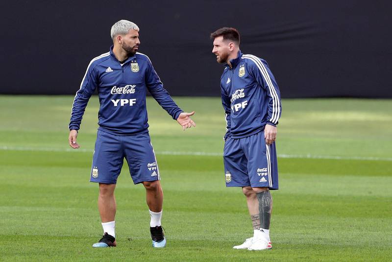 Sergio Aguero, left, and Lionel Messi talk during a practice session in Porto Alegre, Brazil. AP Photo