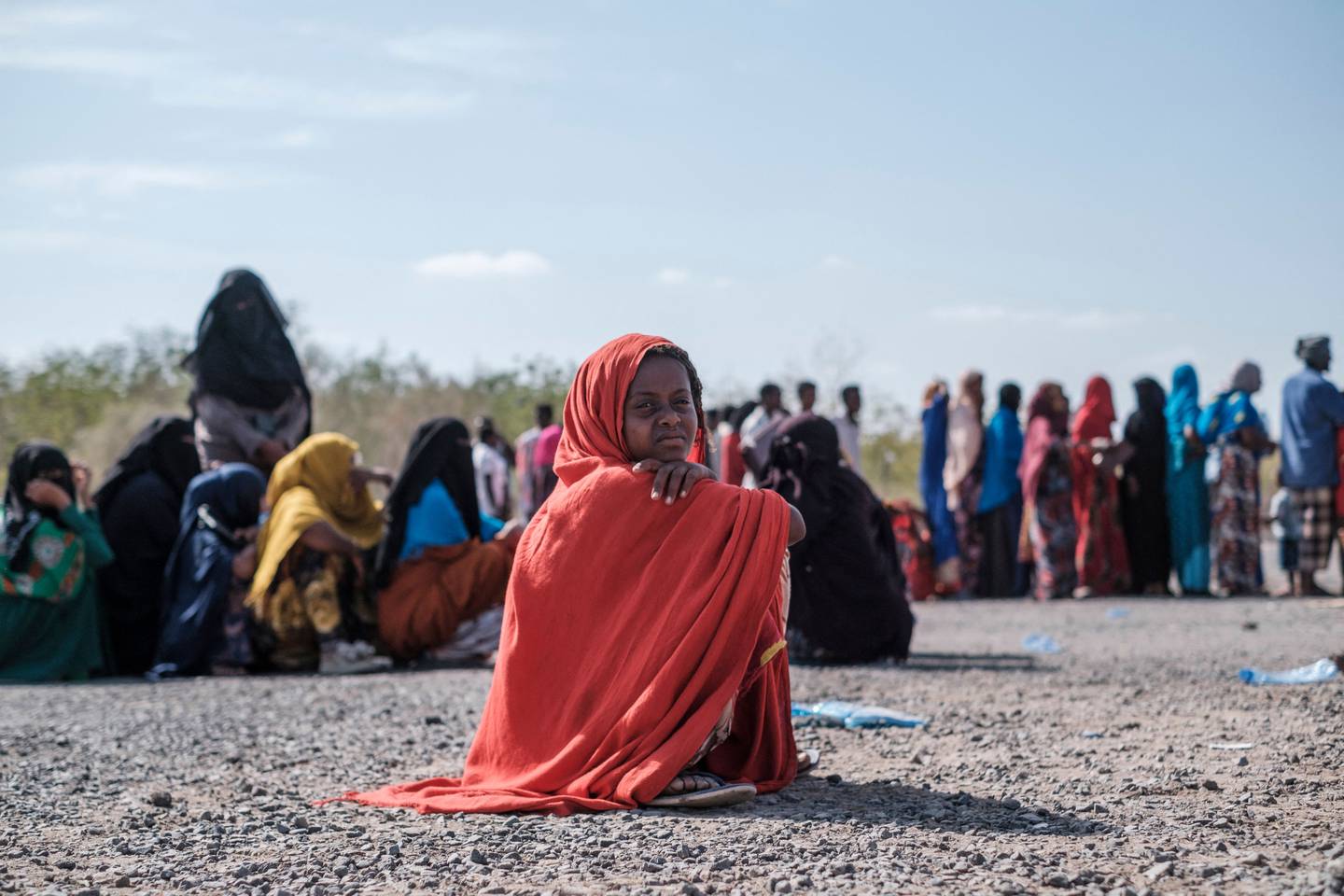 A girl seats as she waits in line to be registered at a compound in  Semera. The conflict in northern Ethiopia began in November 2020 when Prime Minister Abiy Ahmed sent troops to disarm and detain the region's dissident leadership. AFP