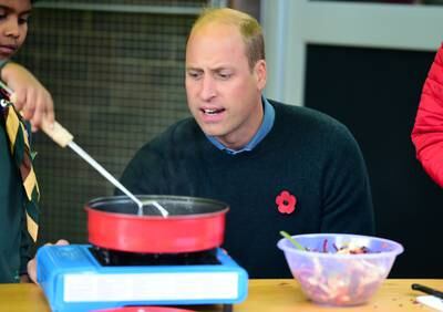 Prince William watches the creation of the seed bombs. Reuters