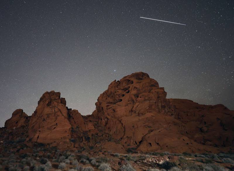 VALLEY OF FIRE STATE PARK, NEVADA - MAY 30: The International Space Station (ISS), reflecting light from the sun, appears to streak over sandstone formations in this 25-second camera exposure on May 30, 2022 in the Valley of Fire State Park, Nevada.    Ethan Miller / Getty Images / AFP
