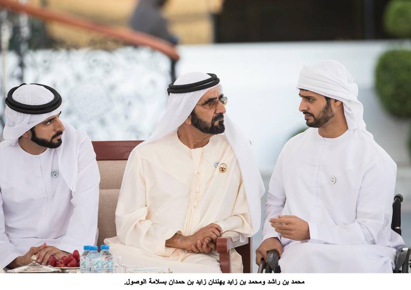 ABU DHABI, UNITED ARAB EMIRATES - February 19, 2018: HH Sheikh Hamdan bin Mohamed Al Maktoum, Crown Prince of Dubai (L), and HH Sheikh Mohamed bin Rashid Al Maktoum, Vice-President, Prime Minister of the UAE, Ruler of Dubai and Minister of Defence (C), speak with HH Sheikh Zayed bin Hamdan bin Zayed Al Nahyan (R), during a Sea Palace barza. ( Ryan Carter for the Crown Prince Court - Abu Dhabi )---