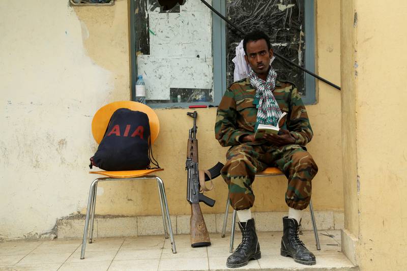 A Tigrayan fighter reads a book as he guards a building in Tigray's capital Mekelle, Ethiopia. Reuters