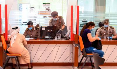 Emiratis and residents visit the passports department in Dubai as officers return to work following the easing of restrictions. AFP
