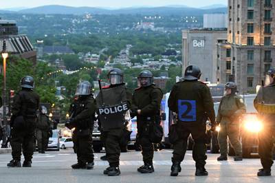 Riot police look on. Martin Ouellet-Diotte / AFP Photo