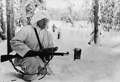 A Finnish radio reporter with a gun and a microphone during coverage on the front line of the 1939-1940 Winter War. Getty Images