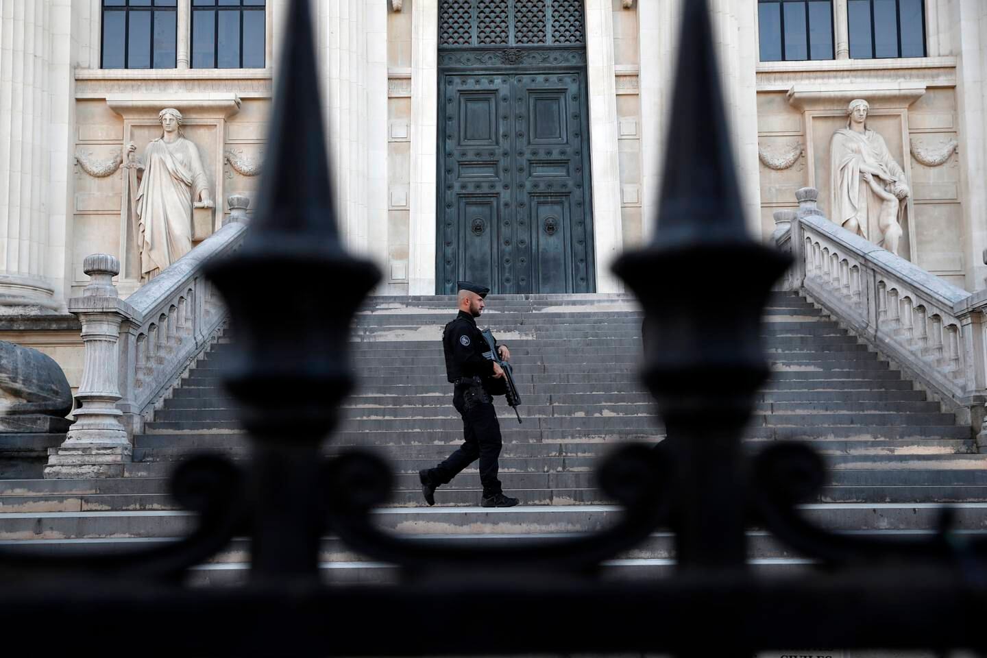 A policeman patrols outside the courthouse in Paris where a trial over the 2015 terror attacks are being held. EPA