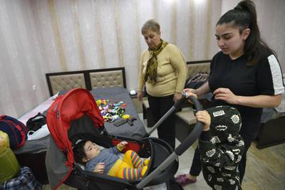 Marine Sargasyan, left, her stepdaughter Anzhelika Astribabayan and her grandchildren children take refuge in a hotel room in Nagorno-Karabakh's main city of Stepanakert after fleeing the nearby town of Shusha. AFP