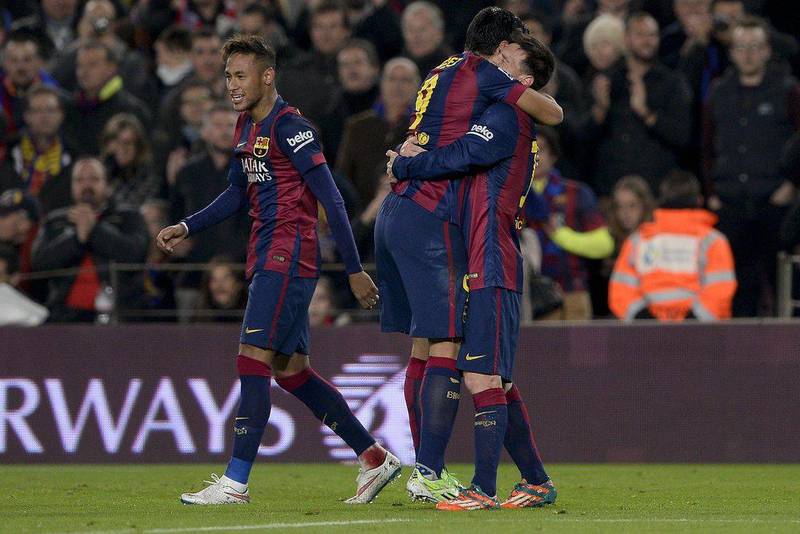 Barcelona's Luis Suarez, right, celebrates with Lionel Messi with Neymar, left, nearby after Suarez's goal for Barcelona during their 3-1 win over Atletico Madrid in La Liga on Sunday night. Josep Lago / AFP / January 11, 2015