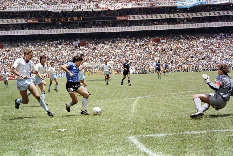 Argentinian forward Diego Maradona passes Terry Butcher on his way to scoring his second goal during the World Cup quarter-final against England in 1986. AFP