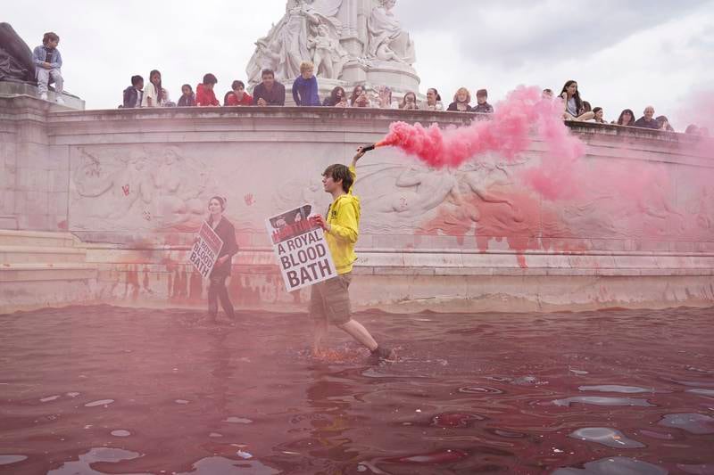 Extinction Rebellion protesters at the Queen Victoria Memorial outside the gates of Buckingham Palace in London, which they daubed with red paint to protest against hunting animals. AP Photo
