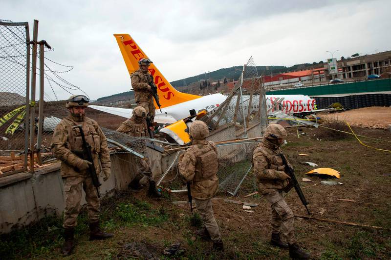 Turkish soldiers secure the wreckage of the Pegasus Airlines Boeing 737 airplane in Istanbul two days after it skidded off the runway upon landing at the Sabiha Gokcen airport.  AFP