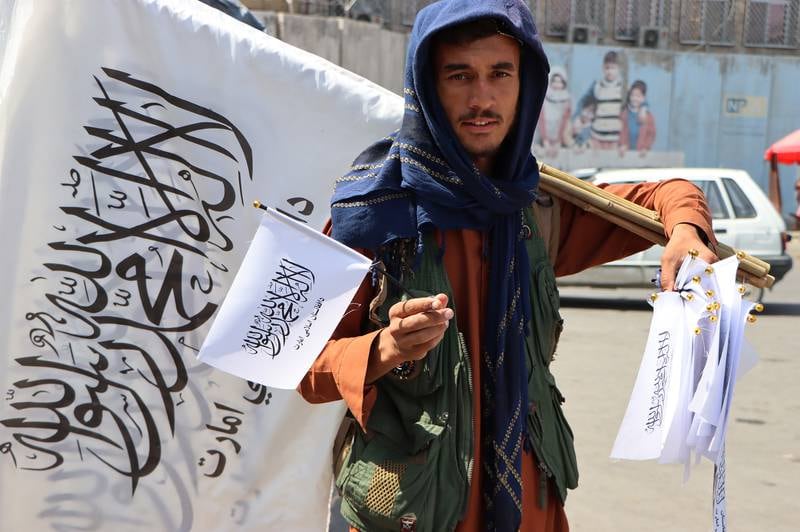 An Afghan man sells Taliban flags in Kabul. EPA