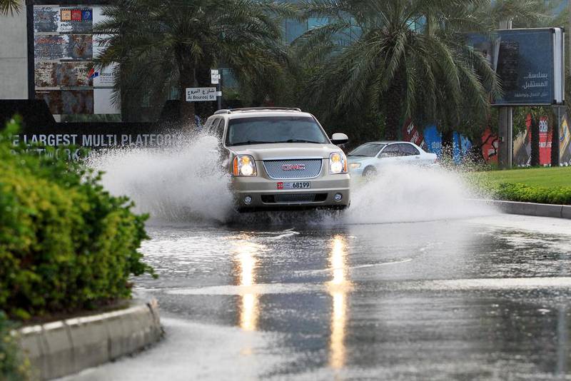 Vehicles drive through flooded sections of Media City in Dubai on December 23, 2013. Christopher Pike / The National