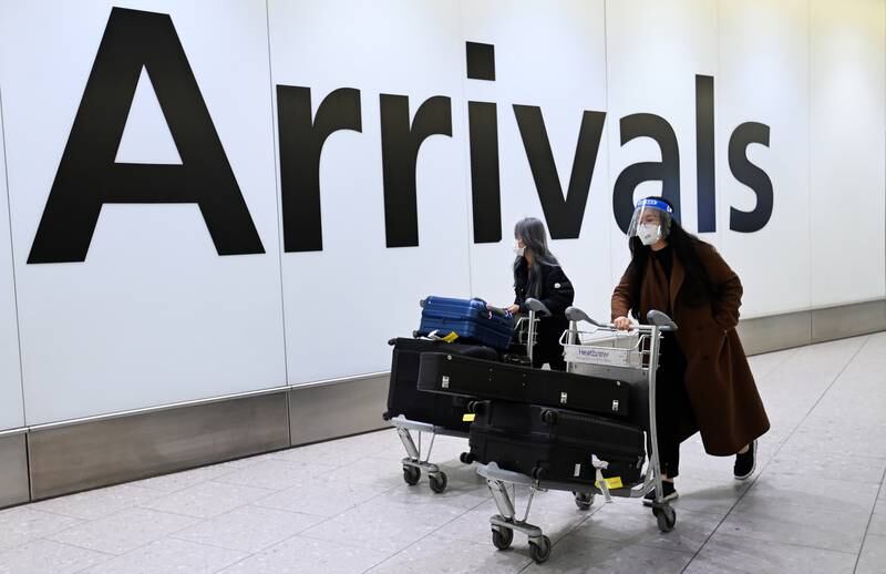 People traveling from China arrive at Heathrow Airport on Wednesday evening. The following day the British government was set to introduce measures to curb the spread of Covid-19, requiring travellers from China to show a negative test taken no more than two days prior to departure. EPA