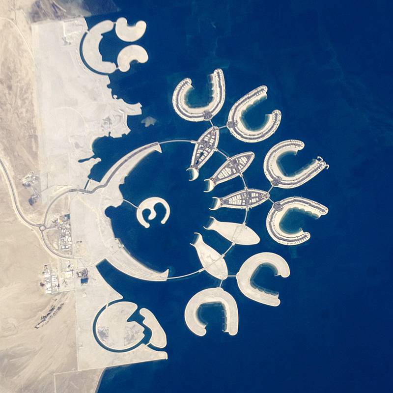RESTRICTED TO EDITORIAL USE MANDATORY CREDIT "AFP PHOTO / HO / NASA" NO MARKETING NO ADVERTISING CAMPAIGNS - DISTRIBUTED AS A SERVICE TO CLIENTS
This picture released by the Nasa on February 8, 2011 is an astronaut photograph acquired on January 23, 2011 showing that construction on the surface of the two southern atolls and petals of the Durrat al Bahrain has yet to begin. Artificial beaches have been created on the inner shorelines of the Crescent and petals, with smaller beaches on the inner ends of the atolls and Hotel Island. The angular outline of the golf course, where many more residences are planned, can be seen between The Crescent and the marina. What may be a second marina is being carved out at the south end of the complex (mirroring the one on the north), though no such marina appears in earlier published plans for Durrat Al Bahrain. At the southern end of Bahrain Island, at the furthest point from the cities of the kingdom, a new complex of 14 artificial islands has risen out of the sea. Designed for residential living and tourism, and aimed at a cosmopolitan clientele, the Durrat Al Bahrain includes 21 square kilometers (8 square miles) of new surface area for more than 1,000 residences, luxury hotels, and shopping malls. The complex has been designed to include: The Islands (six “atolls” leading off five fish-shaped “petals”), The Crescent, Hotel Island, and Durrat Marina in the north. The spectacular outline of this development, and other developments such as the Palm Jumeirah and World Islands in the Persian Gulf, are best appreciated from above. Views from jet liners at high altitude and from orbital platforms such as the International Space Station are the only ways to fully appreciate these sights. (Photo by HO / NASA / AFP)