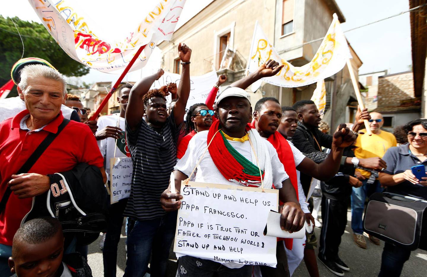 Migrants demonstrate in support of the mayor of the town Domenico Lucano in front of his house in the southern Italian town of Riace, October 6, 2018. REUTERS/Yara Nardi