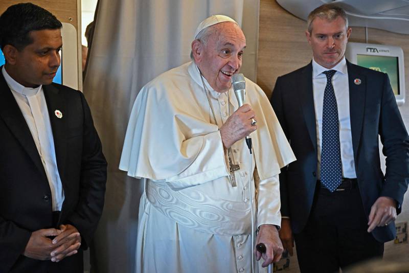 Pope Francis greets journalists onboard the flight  from Rome to Manama. AFP